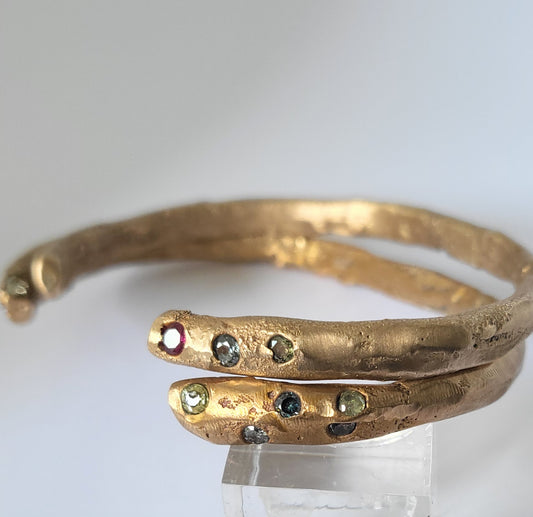 Medieval-inspired handcrafted 9ct gold bangle with rubies and / or sapphires