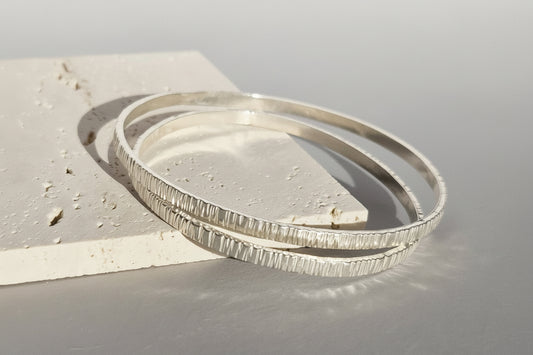 Highly textured handcrafted sterling silver bangle